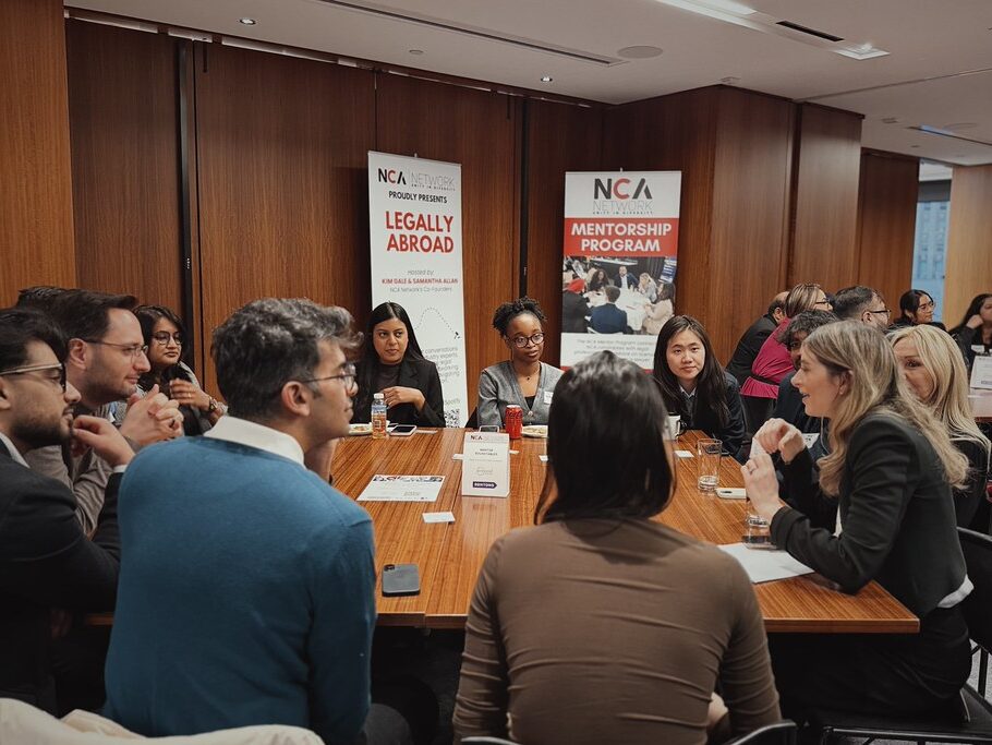 NCA Network members networking around a table at an event