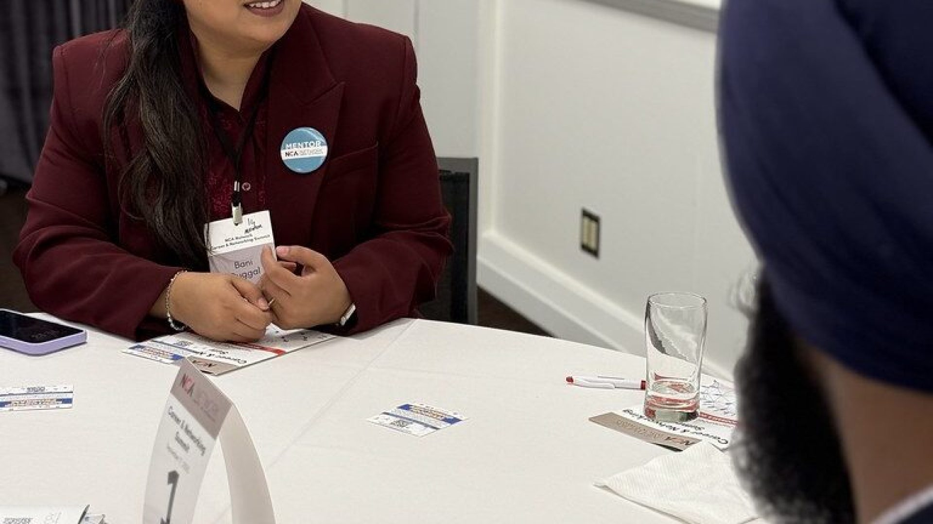 A mentor and mentee talking together at a Mentor Program event